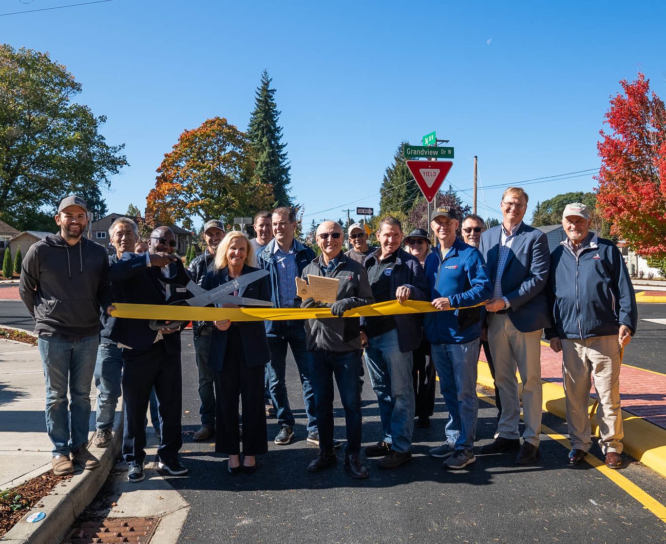 36th and Grandview Roundabout Ribbon Cutting with members of Council and citizens holding ribbon  