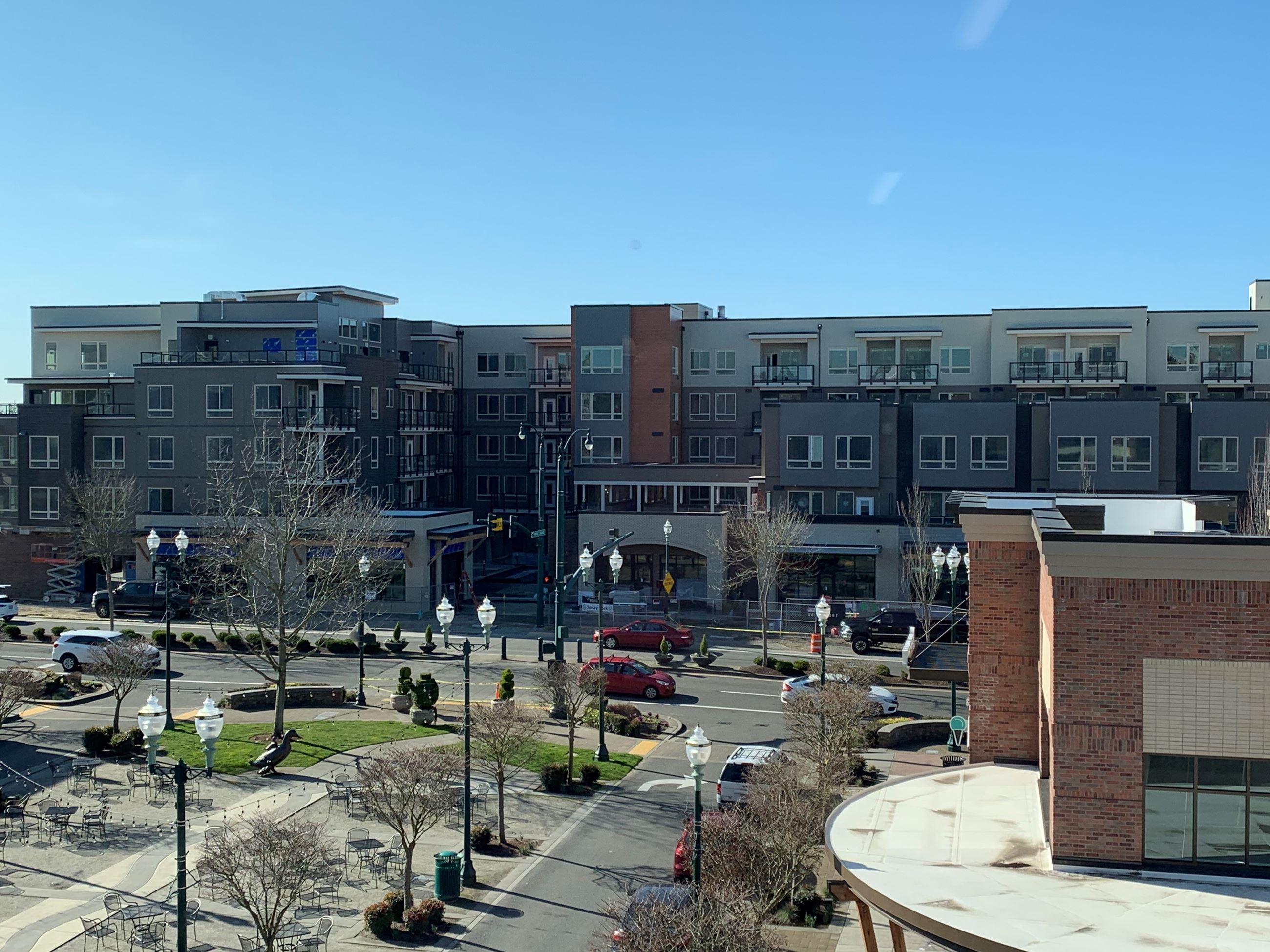 A street lined with lamps and surrounded by several buildings