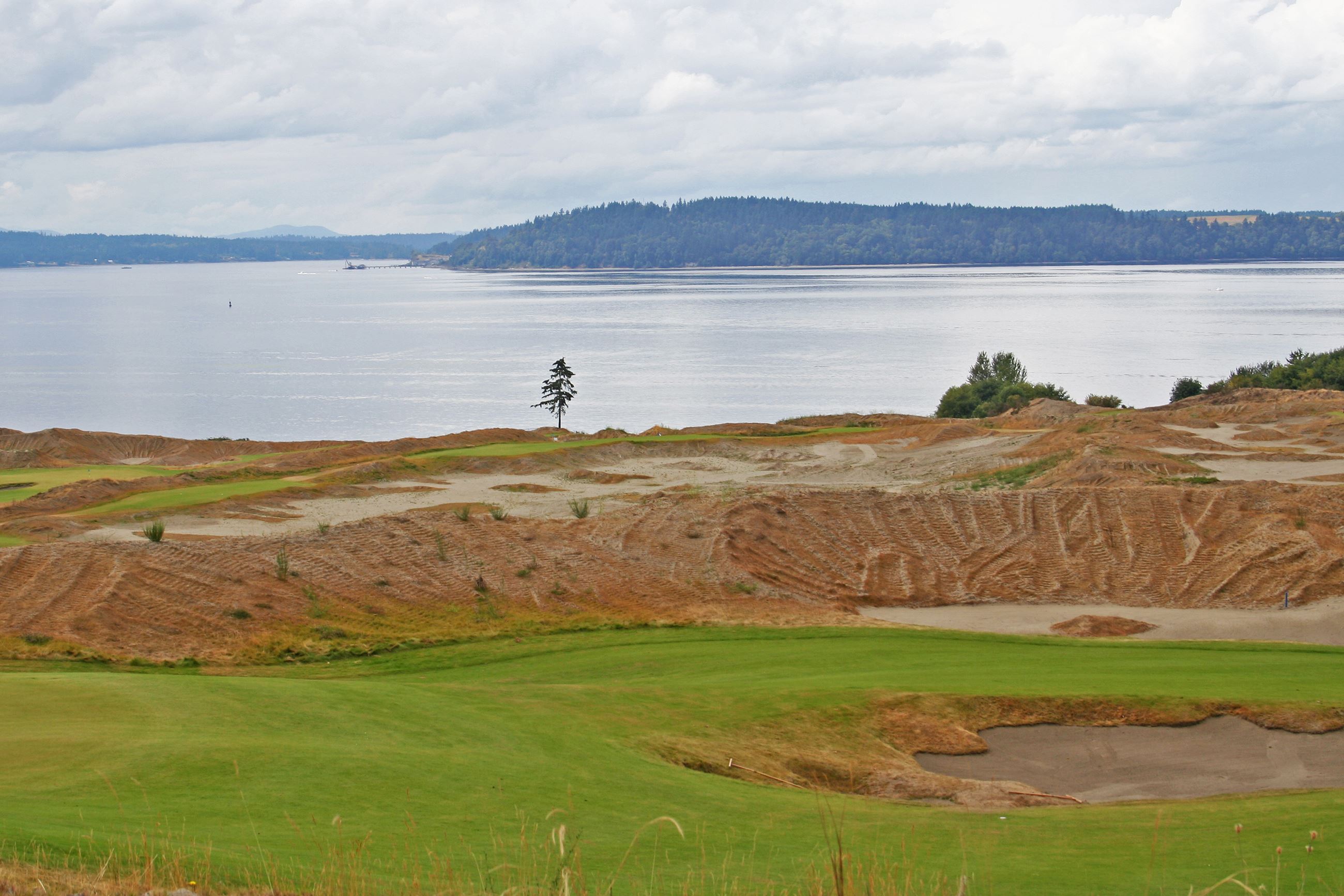 Water along a golf course with hills in the background